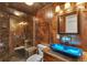 Modern bathroom with glass shower, mosaic tile, and designer sink at 1225 Baker St, Longmont, CO 80501