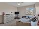 Comfortable bedroom with a neutral color palette and plenty of natural light from the window at 1225 Baker St, Longmont, CO 80501