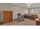 Bedroom with carpet floors, ceiling fan, large windows, and wood dresser at 1225 Baker St, Longmont, CO 80501