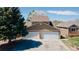 Exterior home elevation with an attached two car garage at 1225 Baker St, Longmont, CO 80501