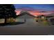 Exterior elevation shows garage doors and lawn at sunset at 1225 Baker St, Longmont, CO 80501