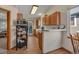 A clean kitchen with wood cabinets and views to the backyard at 1225 Baker St, Longmont, CO 80501