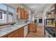 Bright kitchen with stainless appliances and an open layout with connecting rooms at 1225 Baker St, Longmont, CO 80501
