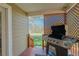 Covered patio featuring a stainless steel grill, wood deck, and view of the spacious backyard at 1225 Baker St, Longmont, CO 80501