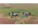 Expansive aerial view of the home with large green acreage, tennis court, outbuildings and mature trees at 11881 County Road 37, Fort Lupton, CO 80621