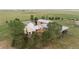 Aerial view of the large property with a custom home, mature trees, and sprawling landscape at 11881 County Road 37, Fort Lupton, CO 80621