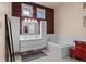 Modern bathroom with a tub, vanity, bright lighting and decorative mirror at 11881 County Road 37, Fort Lupton, CO 80621