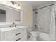Updated bathroom features white marble tile, a shower-tub combination, and modern fixtures at 11881 County Road 37, Fort Lupton, CO 80621