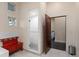Bright bathroom featuring a glass shower and open-doorway leading to another room at 11881 County Road 37, Fort Lupton, CO 80621