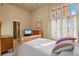 Inviting bedroom features a comfy bed, natural light, and ensuite bathroom at 11881 County Road 37, Fort Lupton, CO 80621