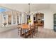 Dining room with natural light, wood table, and views into the open-concept living spaces at 11881 County Road 37, Fort Lupton, CO 80621