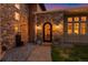 Arched doorway with wrought iron door design and stone facade at 11881 County Road 37, Fort Lupton, CO 80621