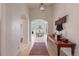 Long hallway with wood floors leading to a dining area, showcasing the home's open layout at 11881 County Road 37, Fort Lupton, CO 80621