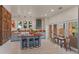Modern kitchen with wood countertops and a spacious island next to a sliding door that leads to the outside at 11881 County Road 37, Fort Lupton, CO 80621