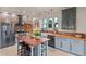 Modern kitchen features a brick backsplash, stainless steel appliances, and a spacious center island at 11881 County Road 37, Fort Lupton, CO 80621