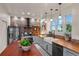 Modern kitchen features a brick backsplash, stainless steel appliances, and a spacious center island at 11881 County Road 37, Fort Lupton, CO 80621