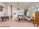 Bright living room featuring high ceilings, a wood-burning stove, and comfortable seating area at 11881 County Road 37, Fort Lupton, CO 80621