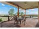 Covered patio with table and chairs offers scenic views at 11881 County Road 37, Fort Lupton, CO 80621