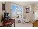 Sitting area features large windows and a comfortable chair and ottoman at 11881 County Road 37, Fort Lupton, CO 80621