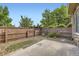 Small backyard features a concrete patio, rock area, and fence at 371 Granby Way # C, Aurora, CO 80011