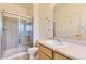 Bathroom with a large mirror, shower, and white fixtures at 371 Granby Way # C, Aurora, CO 80011