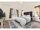 Staged bedroom with bed, decor and neutral paint at 371 Granby Way # C, Aurora, CO 80011