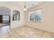 Neutral dining room with large window, tiled floor, and open access to other rooms at 371 Granby Way # C, Aurora, CO 80011