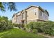 Beautiful townhome showcasing stone accents, manicured lawn, mature landscaping, and a sunny exterior at 371 Granby Way # C, Aurora, CO 80011