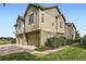 Attractive townhome with beige siding, stone accents, attached garage, and well-maintained landscaping at 371 Granby Way # C, Aurora, CO 80011