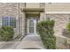 Townhome entrance with stone exterior, landscaped walkway, and inviting front door at 371 Granby Way # C, Aurora, CO 80011