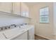 Clean laundry room featuring a washer, dryer, and storage cabinets at 371 Granby Way # C, Aurora, CO 80011