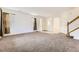 Large, open living room with carpet and natural light through multiple windows at 371 Granby Way # C, Aurora, CO 80011