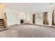 Bright living room with neutral carpet, fireplace, archways, and natural light at 371 Granby Way # C, Aurora, CO 80011