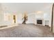 Spacious living room featuring a fireplace, staircase, and open layout to other rooms at 371 Granby Way # C, Aurora, CO 80011