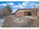 Backyard featuring a fire pit surrounded by walkways, perfect for outdoor gatherings at 6630 E Virginia Ave, Denver, CO 80224