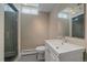 Updated bathroom with modern vanity, tiled floor, and glass-enclosed shower at 6630 E Virginia Ave, Denver, CO 80224