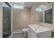Well-lit basement bathroom featuring a glass door shower and modern sink at 6630 E Virginia Ave, Denver, CO 80224