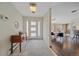 Inviting foyer with tile flooring, console table, and a view into the open floor plan at 6630 E Virginia Ave, Denver, CO 80224