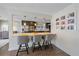 Well-lit kitchen bar with seating, pendant lighting, and stylish decor connecting to the dining area at 6630 E Virginia Ave, Denver, CO 80224