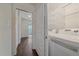 Convenient laundry area with washer, dryer, and shelving for organized storage at 6630 E Virginia Ave, Denver, CO 80224
