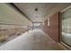 Covered patio featuring a concrete floor, brick wall, and roll-up shade at 6630 E Virginia Ave, Denver, CO 80224