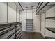 Organized walk-in closet with custom shelving and storage solutions for optimal space utilization at 6630 E Virginia Ave, Denver, CO 80224