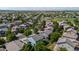 Residential neighborhood aerial view showing rooftops, green trees, and blue house at 11861 Fairplay St, Commerce City, CO 80603