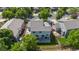 Aerial view of fenced backyard with a blue house, a green lawn, and patio furniture at 11861 Fairplay St, Commerce City, CO 80603