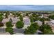 Wide aerial shot showcasing neighborhood homes, lush trees, and distant mountains at 11861 Fairplay St, Commerce City, CO 80603