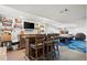Finished basement bar area featuring wood bar, liquor shelves, and TV at 11861 Fairplay St, Commerce City, CO 80603