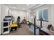 Basement workout room with exercise bike, weight bench and shelving units at 11861 Fairplay St, Commerce City, CO 80603
