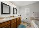 A clean bathroom with double sinks and warm accents at 11861 Fairplay St, Commerce City, CO 80603
