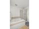 A bright bathroom featuring a standalone bathtub and glass enclosed shower at 11861 Fairplay St, Commerce City, CO 80603