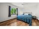 Bright bedroom with hardwood floors and a large window with trees in the background at 11861 Fairplay St, Commerce City, CO 80603